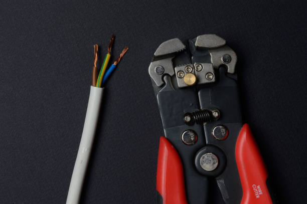 istock wire cutters and stripped wire lie against a dark background. close-up. 1305124363