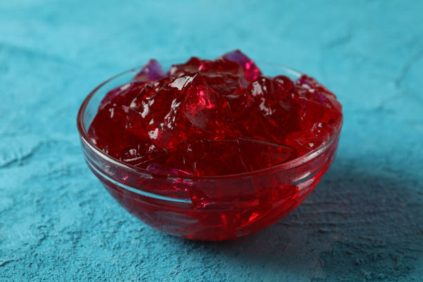 istock Bowl of strawberry jelly on blue table 1305124703