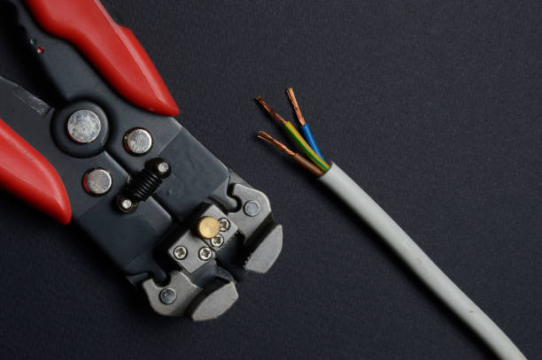 istock wire cutters and stripped wire lie against a dark background. close-up. 1305124952