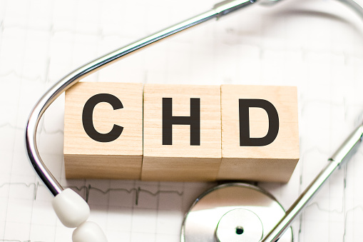 CHD word written on wooden blocks and stethoscope on light background. Healthcare conceptual for hospital, clinic and medical busines. CHD acronym Congenital Heart Defect
