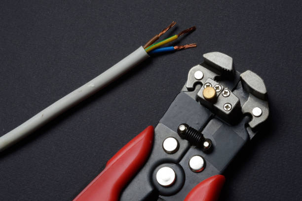 istock wire cutters and stripped wire lie against a dark background. close-up. 1305125190