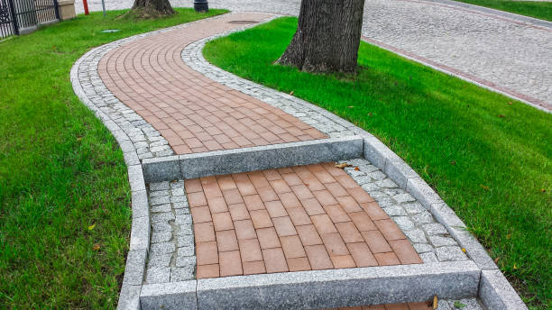 istock Stairs with red gray cobblestones, among the grass 1305128419