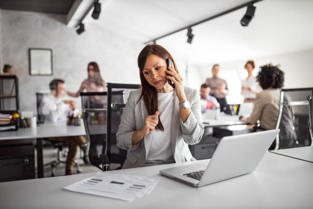 istock Employee woman resting from work at office, using phone. 1305131154
