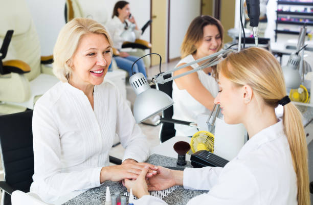 istock Laughing women doing manicure 1305133613