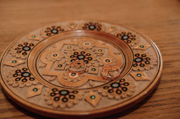 istock Wedding rings on a golden plate 1305135372
