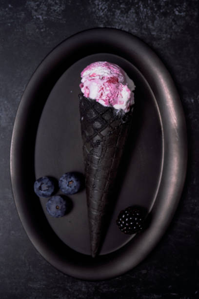 istock Berry Ice Cream in a Black Ice Cream Cone 1305135727