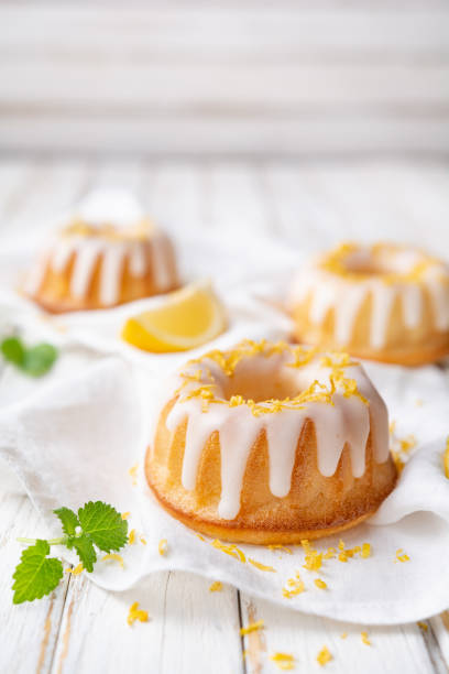 Mini lemon bundt cakes topped with lemon glaze stock photo