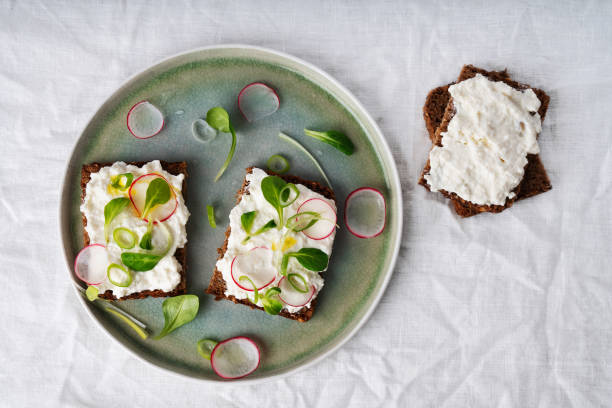 Vegan sandwiches with vegan cottage cheese, green onion, raddish and extra virgin olive oil stock photo