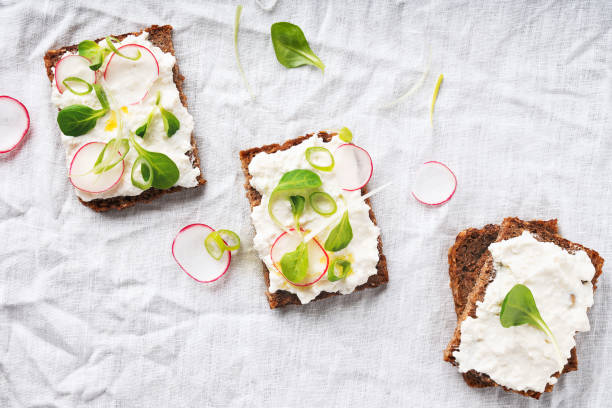 Vegan sandwiches with vegan cottage cheese, green onion, raddish and extra virgin olive oil stock photo