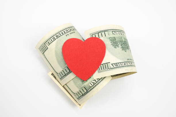 istock Dollars and heart, on an isolated white background 1305139060