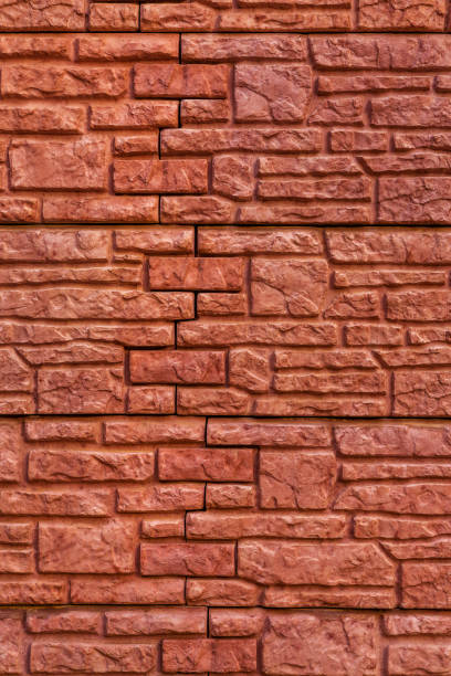 istock Background texture red, stone brick wall. Surface with a brickwork of bricks of different sizes 1305139795