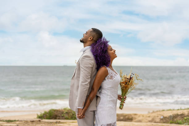 glückliches junges paar mit dem rücken zueinander - wedding black american culture bride stock-fotos und bilder