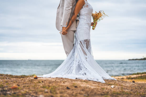 istock Bride and groom holding hands 1305141475