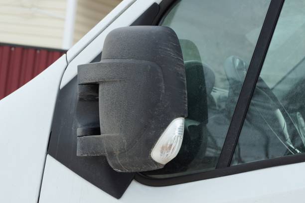 istock one large black closed plastic car mirror next to the gray glass 1305142927
