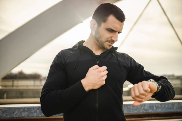 istock Handsome man checking workout data on fitness tracker after intensive training outdoors 1305142980