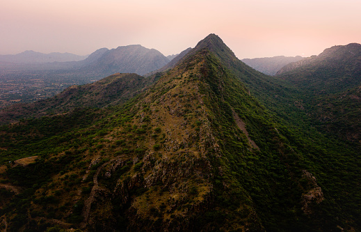 View across the Aravali hills with peaks and sharp slopes at sunset near Ajmer, Rajasthan, India.