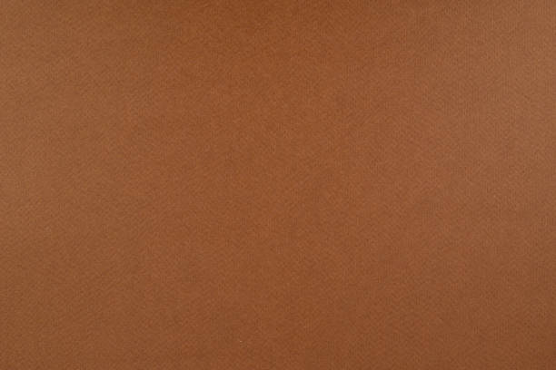 istock Light brown paper background. Russet brown colour paper texture. 1305144621
