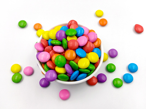 Clear bowl of candy corn on white kitchen counter