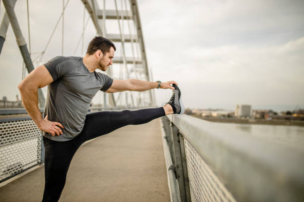 istock Fit man stretching muscles after intensive running outdoors 1305146987