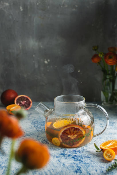 istock Citrus blood oranges tea with splashes and steam 1305147065