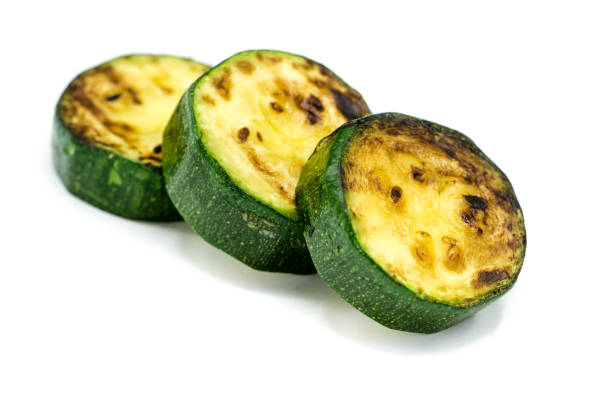istock Grilled zucchini isolated on white background 1305147760