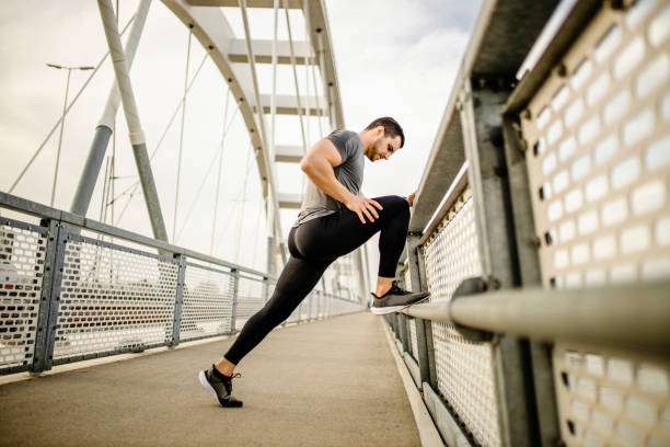istock Fit man stretching muscles after intensive running outdoors 1305148905