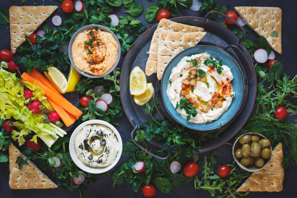 istock Various types of hummus  dips and raw vegetarian snacks on dark wooden table 1305148969