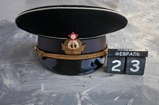 Wooden calendar with the date of February 23, and  headgear officer of the Navy of the USSR and Russia Defender of the Fatherland Day. Men day in Russia. Text in Russian on February 23.
