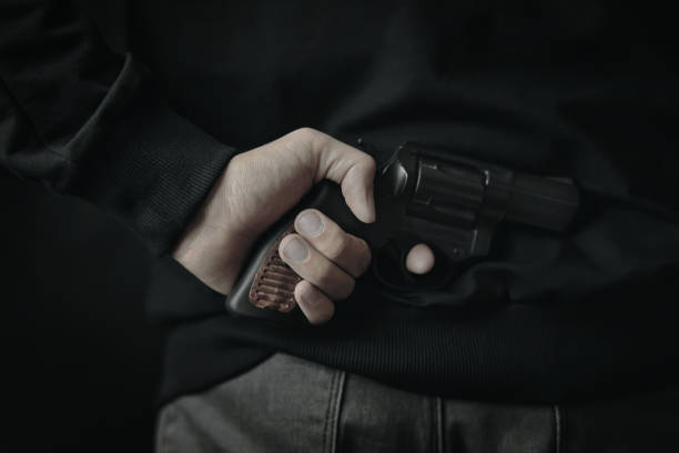 istock A man with a revolver on his back. 1305149797