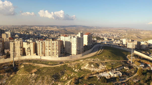 istock Palestinian Anata Refugees Camp with security wall,jerusalem - aerial view 1305152508