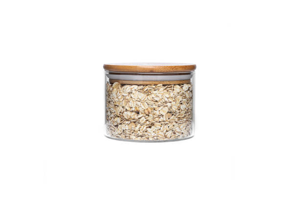 istock Oat flakes in a glass jar isolated on a white background 1305152547