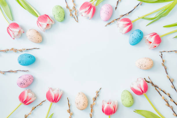 istock Flat lay easter composition with pink tulips and eggs on color background 1305153747