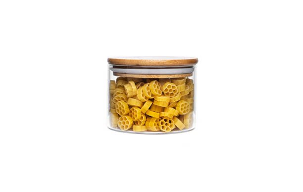 istock Rotelle pasta in glass jar isolated on white background 1305155209
