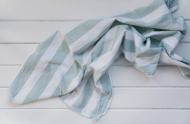 istock Green tablecloth on white wooden 1305157137