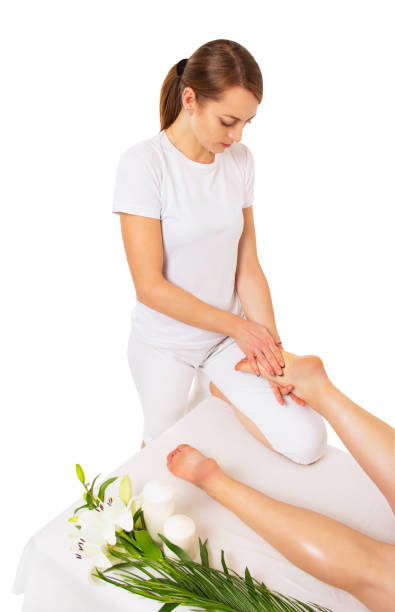 istock Foot massage on white background. Beautiful woman masseuse at work 1305157644