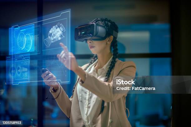 Woman Wearing A Vr Headset At Work Stock Photo - Download Image Now - Virtual Reality Simulator, Virtual Reality, Virtual Reality Point of View