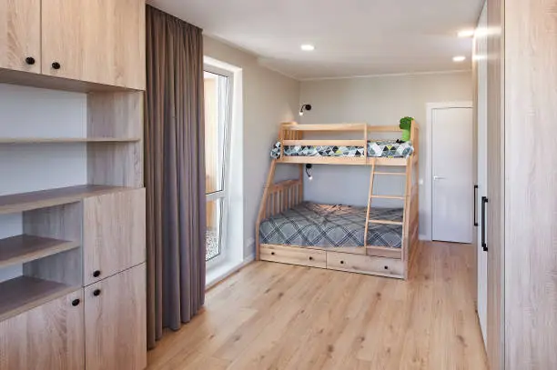 Children's bedroom in new luxury home with bunk beds and colorful comforters. nobody
