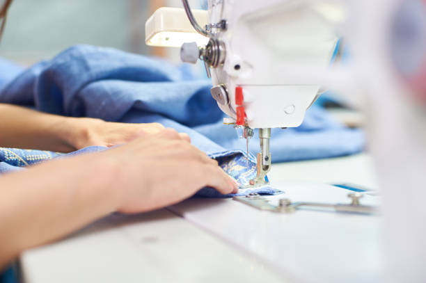 istock Industrial sewing machine and hand seamstress. Close-up 1305159642