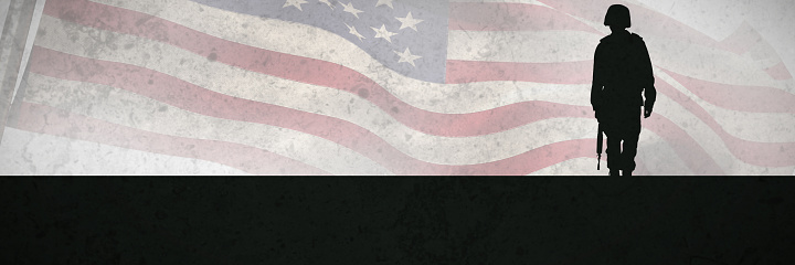 Low angle view of American flag against grey background