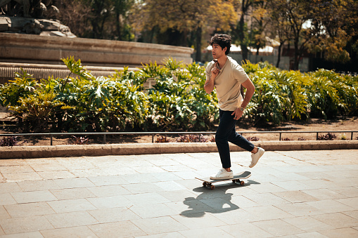 a man rides a skateboard, during day