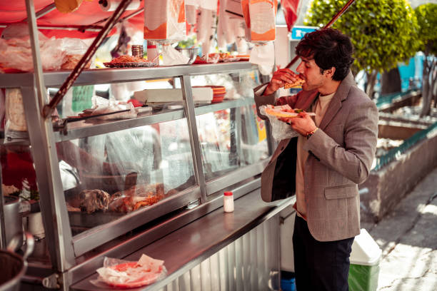 Young man eating at fast food kiosk