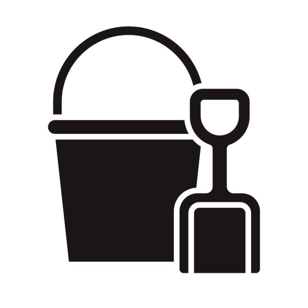 Sand Bucket and Shovel Travel Glyph Icon A black glyph icon on a transparent background. You can place onto any coloured background (no white box behind icon). File is built in CMYK for optimal printing with a 100% black fill. sand pail and shovel stock illustrations