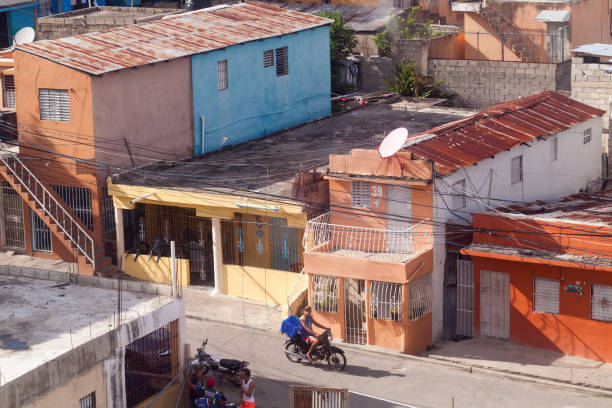 Tbilisi, Georgia - October 25, 2020: Old town street near botanic garden, people and autos, two girl on the scooter
