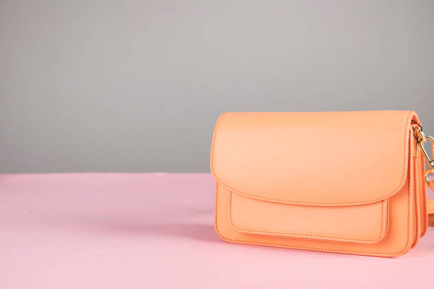 istock orange bag on pink background 1305169580