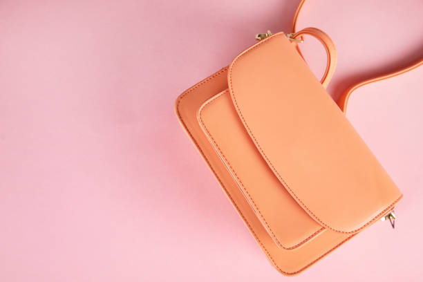 istock orange bag on pink background 1305169588