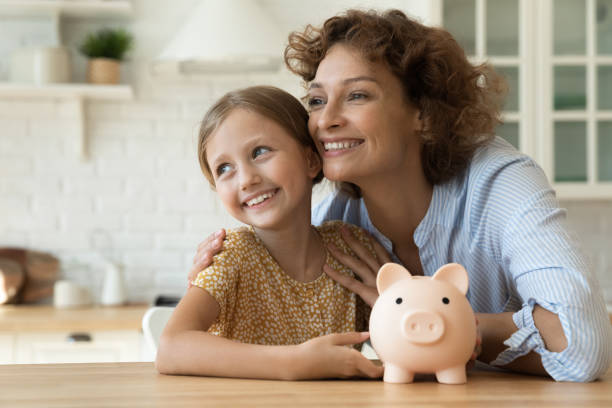 istock Dreamy mom and small child saving money for future vacation 1305169694