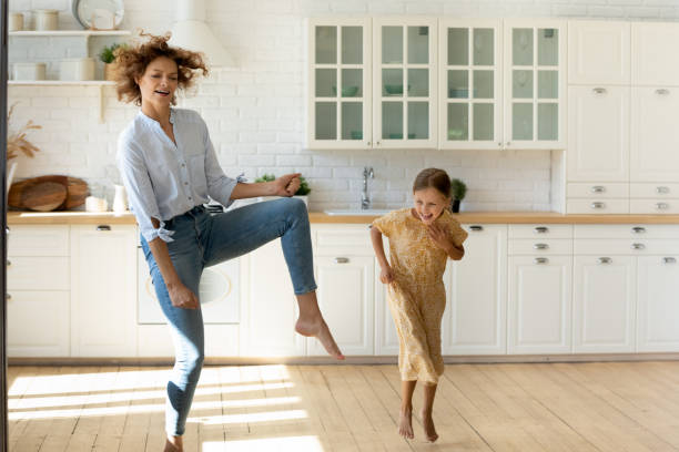istock Emotional young mother and small daughter having fun at kitchen 1305169706