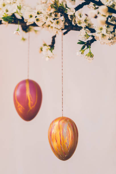 istock Still life close up with blossom branches and pussy willow decorated with self painted Easter eggs on a bright rustic wooden background with copy space 1305170697