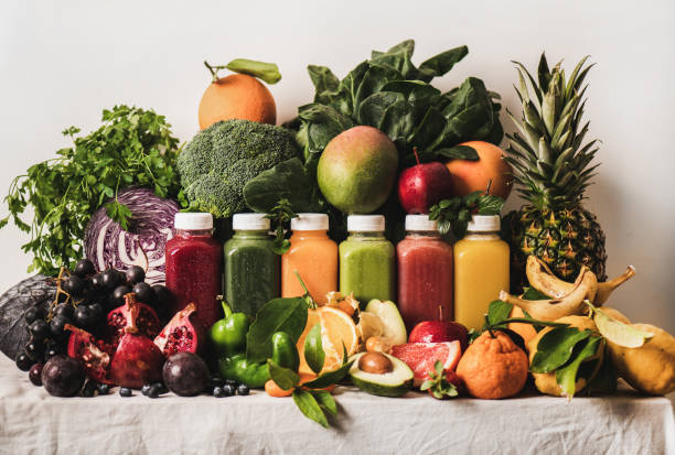 assortment of fresh vegan smoothies and ingredients on table - blender apple banana color image imagens e fotografias de stock