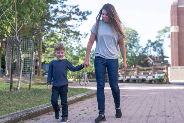 istock A mother walking through a park with her son 1305171817